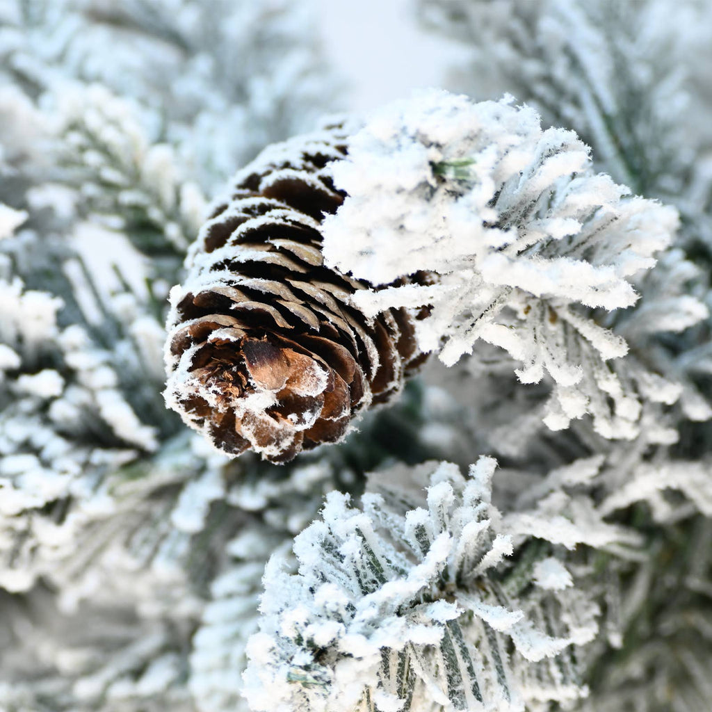 Flocked Christmas tree with potted base and 3 pine cones