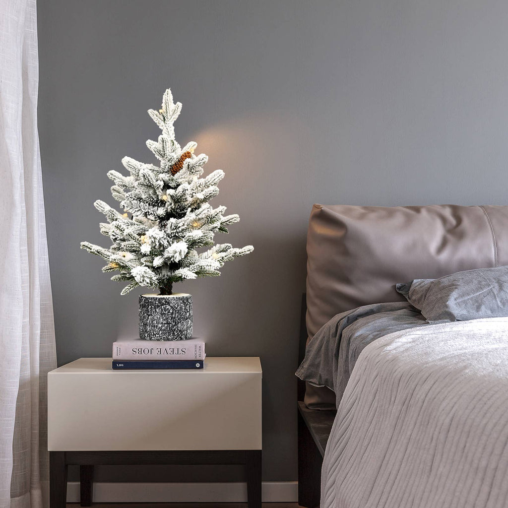 Flocked Christmas tree with potted base and 3 pine cones
