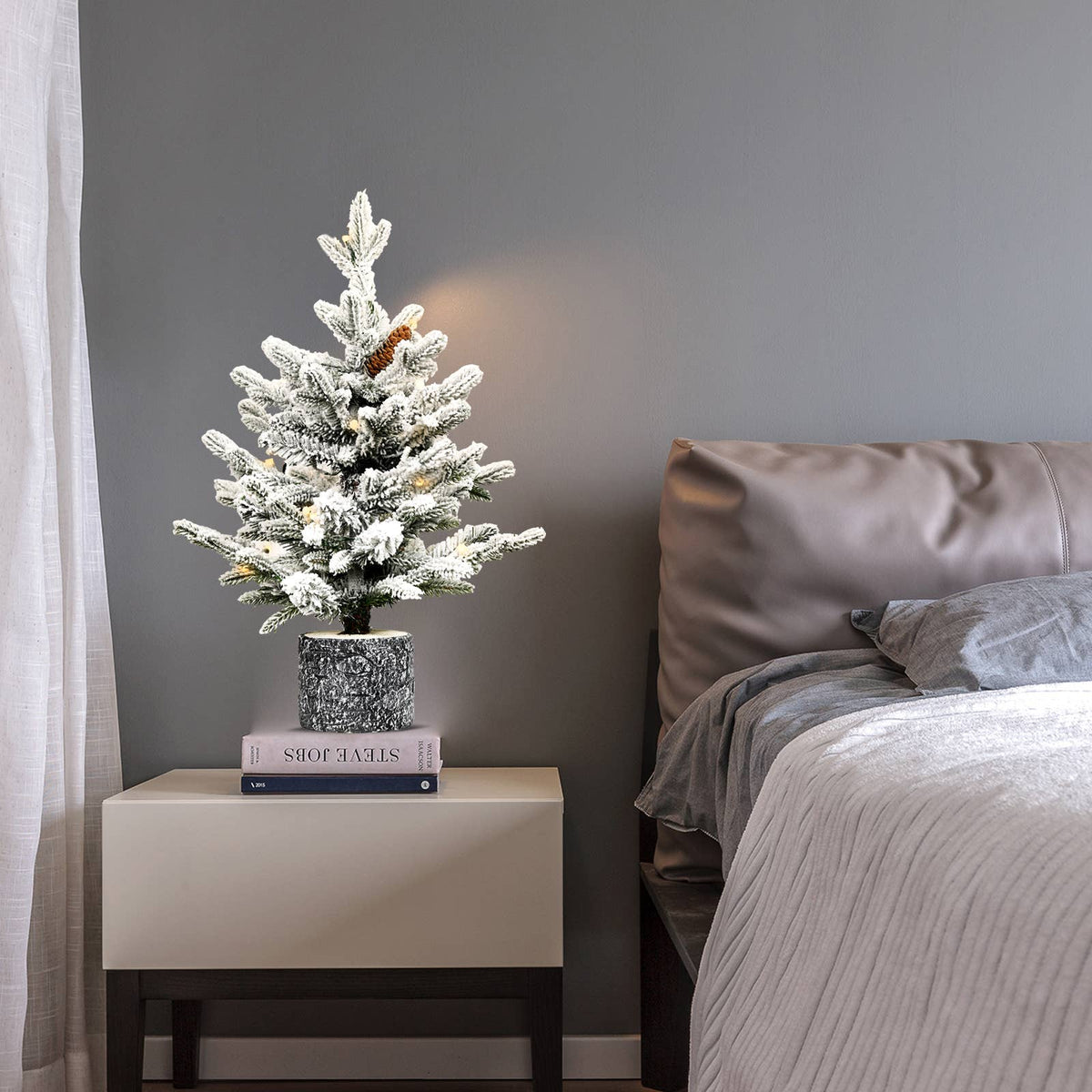 Flocked Christmas tree with potted base and 3 pine cones